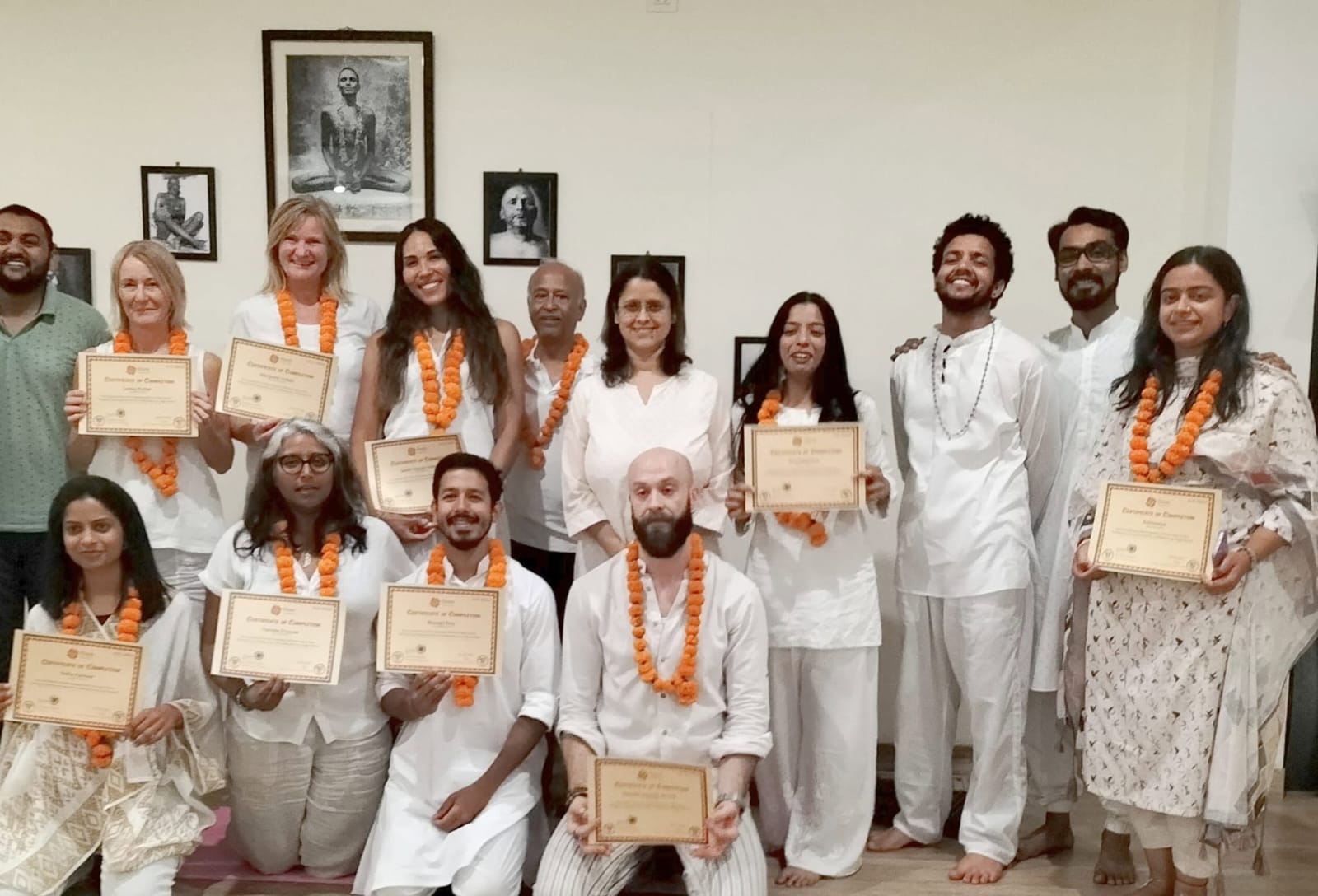 Graduates of the Light House Yoga Teacher Training holding certificates